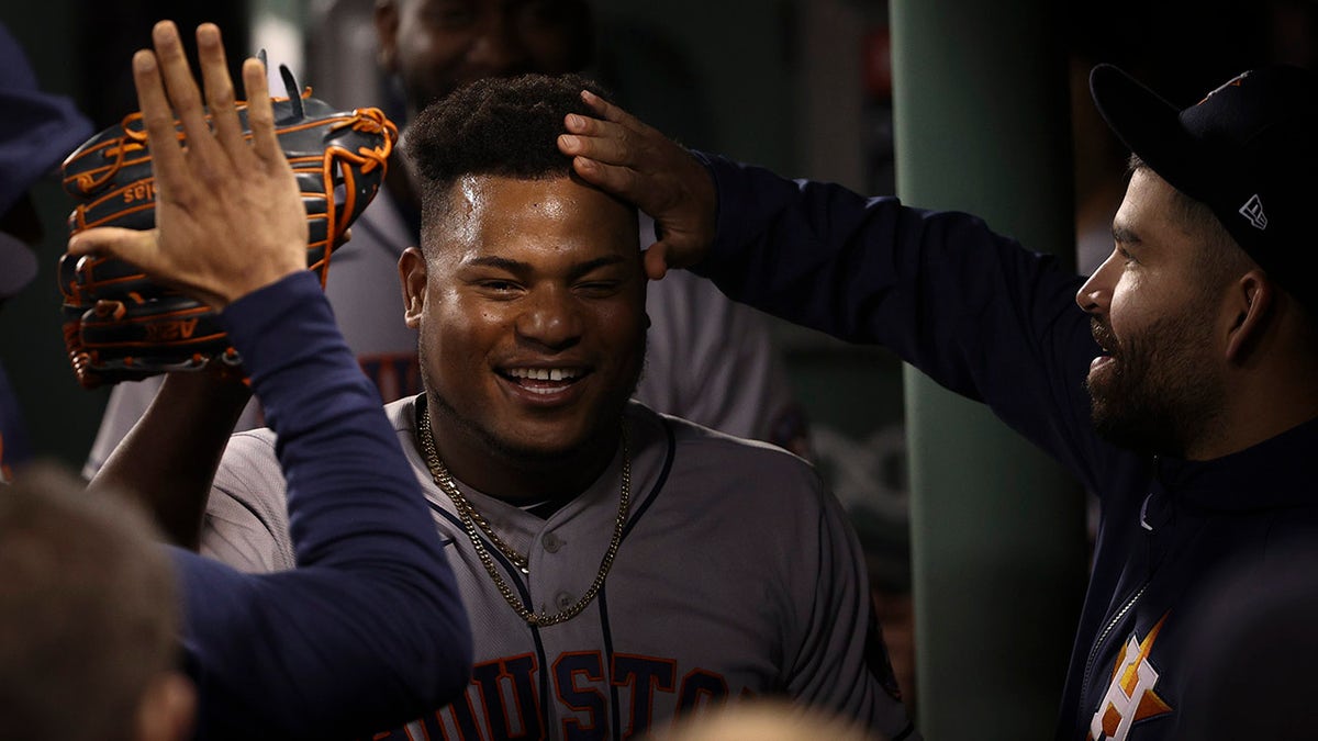 Houston Astros starting pitcher Framber Valdez celebrates in the dugout after the eighth inning in Game 5 of the American League Championship Series against the Boston Red Sox Wednesday, Oct. 20, 2021, in Boston.