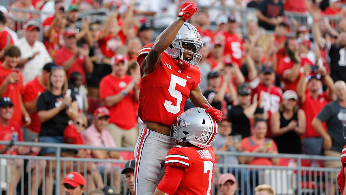 Ohio State receiver Garrett Wilson (5) celebrates his touchdown against Tulsa during the second half of an NCAA college football game Saturday, Sept. 18, 2021, in Columbus, Ohio.