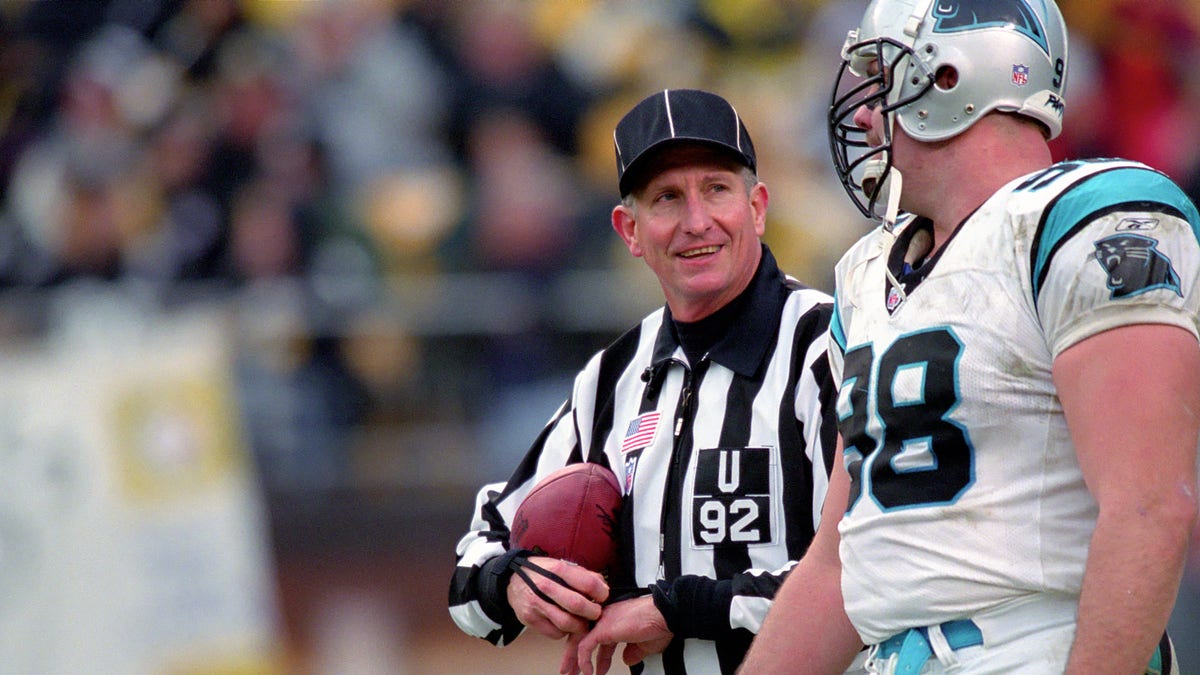 National Football League umpire Carl Madsen talks to defensive lineman Shane Burton #98 of the Carolina Panthers during a game against the Pittsburgh Steelers at Heinz Field on Dec. 15, 2002 in Pittsburgh, Pennsylvania.  