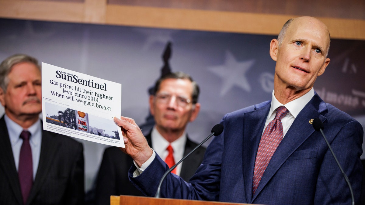 WASHINGTON, DC - OCTOBER 27: Sen. Rick Scott (R-FL) holds up an article from the Sun Sentinel as he speaks alongside other Republican Senators during a press conference on rising gas an energy prices at the U.S. Capitol on October 27, 2021 in Washington, DC. Republicans are placing blame on the Biden Administration for the quickly rising gas prices this year as predictions estimate that heating costs this winter will rise significantly as well. (Photo by Samuel Corum/Getty Images)