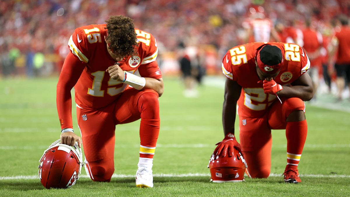 Patrick Mahomes #15 and Clyde Edwards-Helaire #25 of the Kansas City Chiefs take a knee prior to a game against the Buffalo Bills  at Arrowhead Stadium on Oct. 10, 2021 in Kansas City, Missouri.