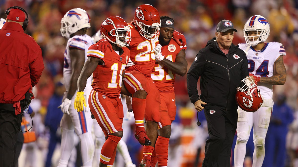 Darrel Williams #31 and Tyreek Hill #10 help Clyde Edwards-Helaire #25 of the Kansas City Chiefs off the field after he was injured during the second half of a game against the Buffalo Bills at Arrowhead Stadium on Oct. 10, 2021 in Kansas City, Missouri.