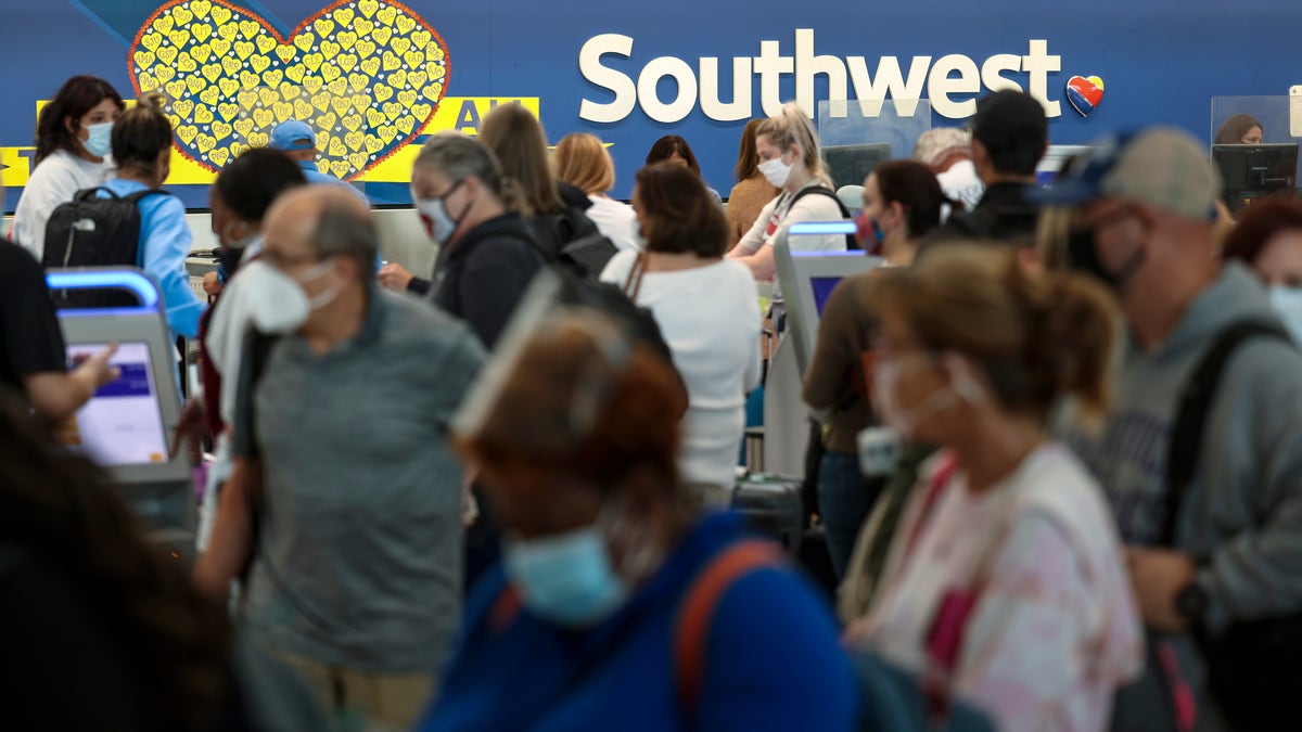 BALTIMORE, MARYLAND - OCTOBER 11: Travelers wait to check in at the Southwest Airlines ticketing counter at Baltimore Washington International Thurgood Marshall Airport on October 11, 2021 in Baltimore, Maryland. Southwest Airlines is working to catch up on a backlog after canceling hundreds of flights over the weekend, blaming air traffic control issues and weather. (Photo by Kevin Dietsch/Getty Images)