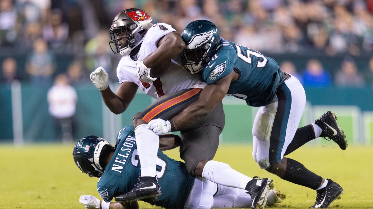 Genard Avery #58 and Steven Nelson #3 of the Philadelphia Eagles tackle Leonard Fournette #7 of the Tampa Bay Buccaneers at Lincoln Financial Field on Oct. 14, 2021 in Philadelphia, Pennsylvania.