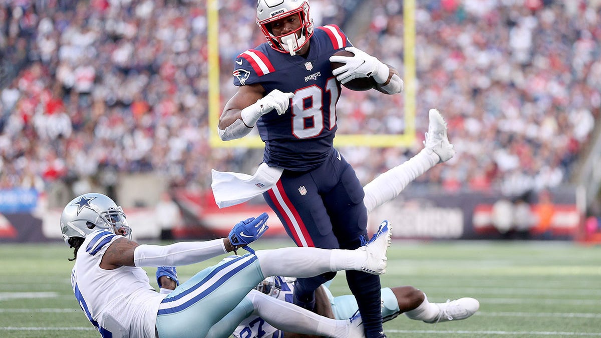 Jonnu Smith (81) of the New England Patriots runs with the ball against Trevon Diggs (7) of the Dallas Cowboys in the first quarter at Gillette Stadium Oct. 17, 2021 in Foxborough, Mass.
