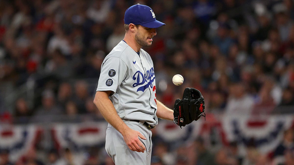 ATLANTA, GEORGIA - OCTOBER 17: Max Scherzer #31 of the Los Angeles Dodgers tosses the ball in the air in between pitches against the Atlanta Braves in the first inning of Game Two of the National League Championship Series at Truist Park on October 17, 2021 in Atlanta, Georgia.
