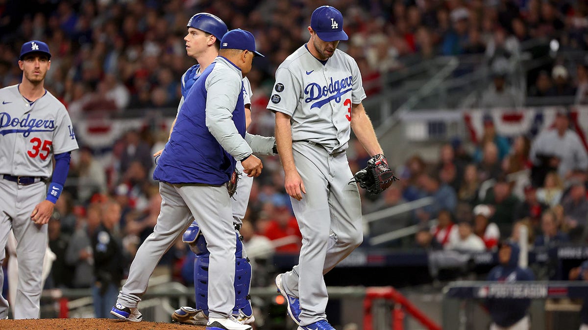 ATLANTA, GEORGIA - OCTOBER 17: Manager Dave Roberts takes Max Scherzer #31 of the Los Angeles Dodgers out of the game against the Atlanta Braves in the fifth inning of Game Two of the National League Championship Series at Truist Park on October 17, 2021 in Atlanta, Georgia.