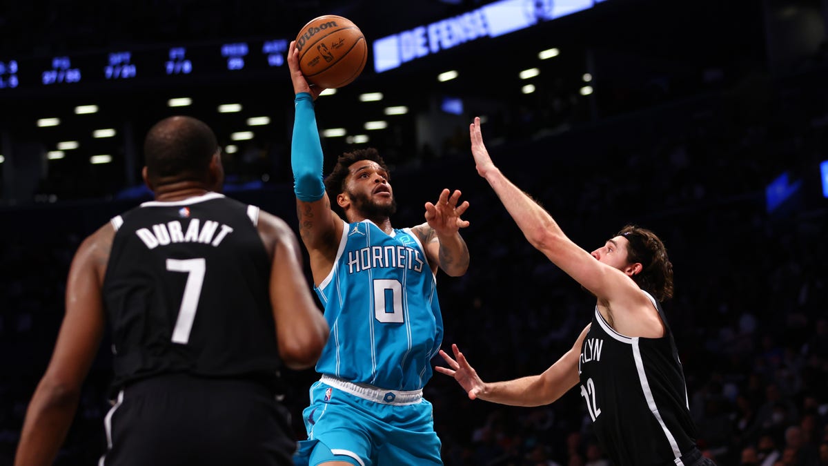 Miles Bridges #0 of the Charlotte Hornets attempts a shot as Kevin Durant #7 and Joe Harris #12 of the Brooklyn Nets defend during the second half of a game at Barclays Center on Oct. 24, 2021 in New York City. The Hornets defeated the Nets 111-95." (Photo by Rich Schultz/Getty Images)
