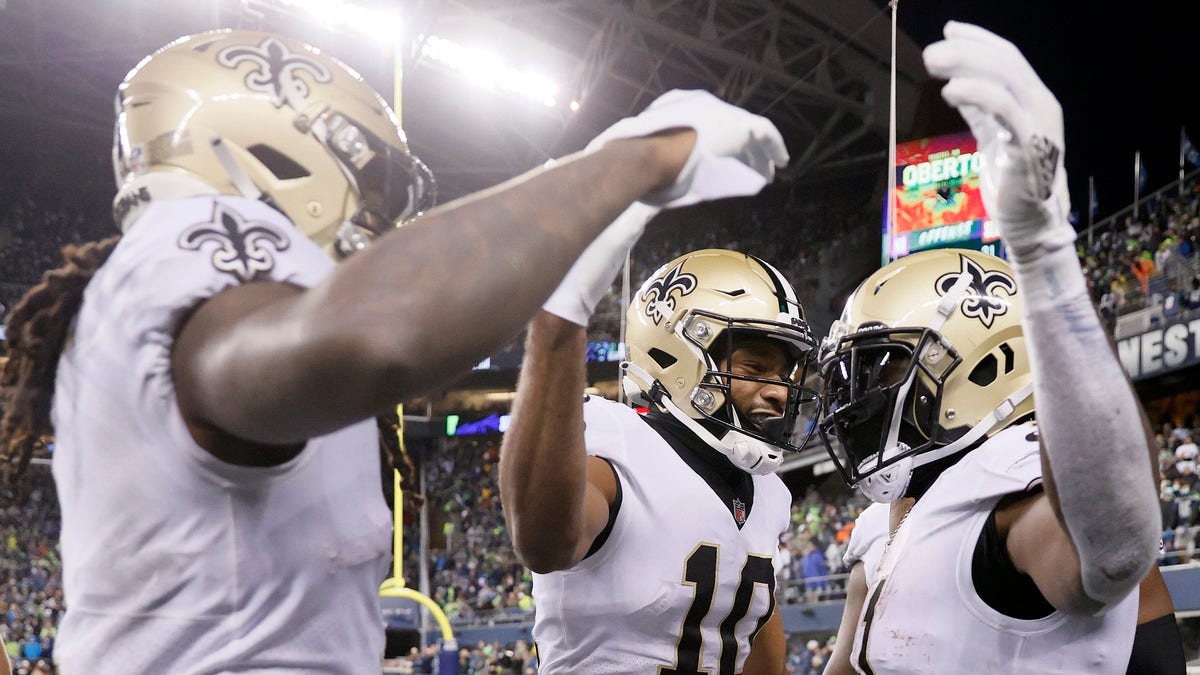 SEATTLE, WASHINGTON - OCTOBER 25: Alvin Kamara #41 of the New Orleans Saints celebrates a touchdown with Tre'Quan Smith #10 and Marquez Callaway #1 during the first half against the Seattle Seahawks at Lumen Field on October 25, 2021 in Seattle, Washington. (Photo by Steph Chambers/Getty Images)