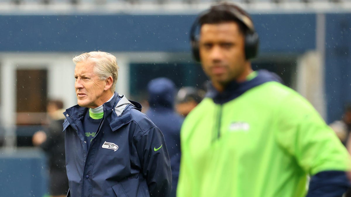 Head Coach Pete Carroll of the Seattle Seahawks looks on alongside Russell Wilson #3 before the game against the New Orleans Saints at Lumen Field on Oct. 25, 2021 in Seattle, Washington.