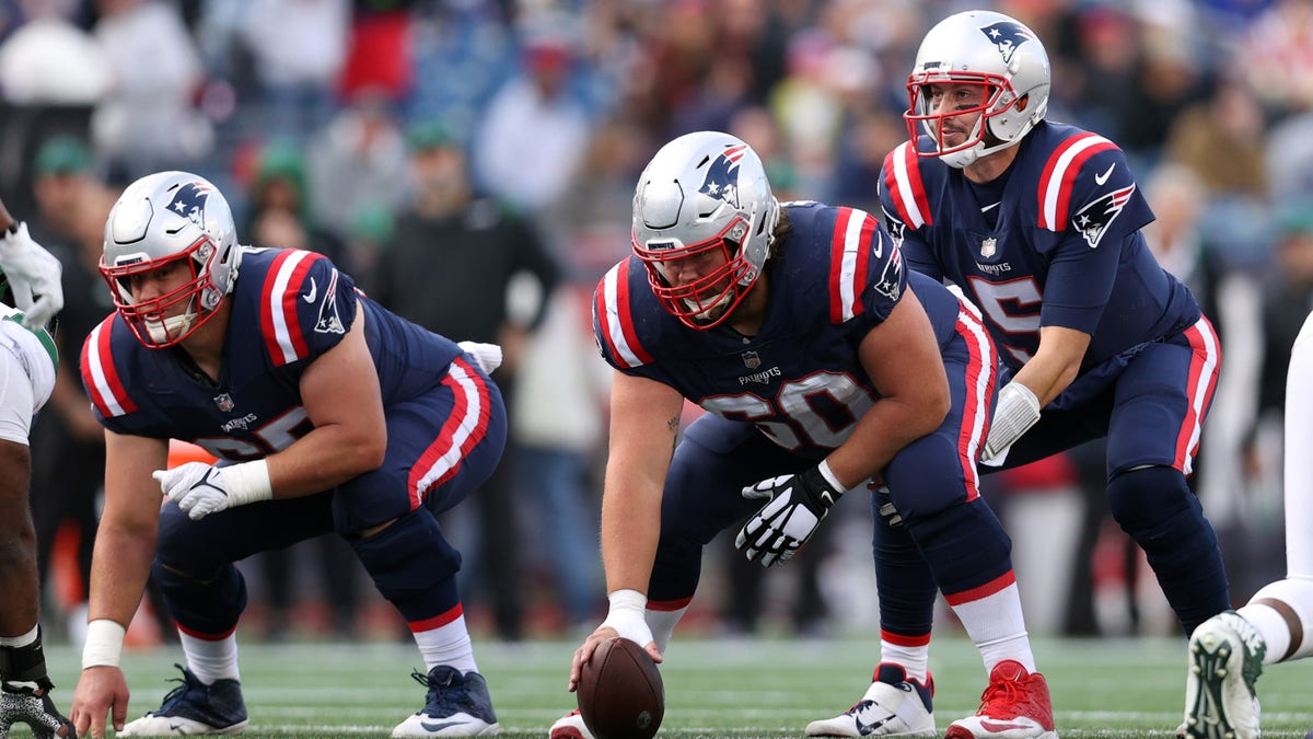 Brian Hoyer of the New England Patriots lines up behind David Andrews against the New York Jets at Gillette Stadium on Oct. 24, 2021, in Foxborough, Massachusetts.