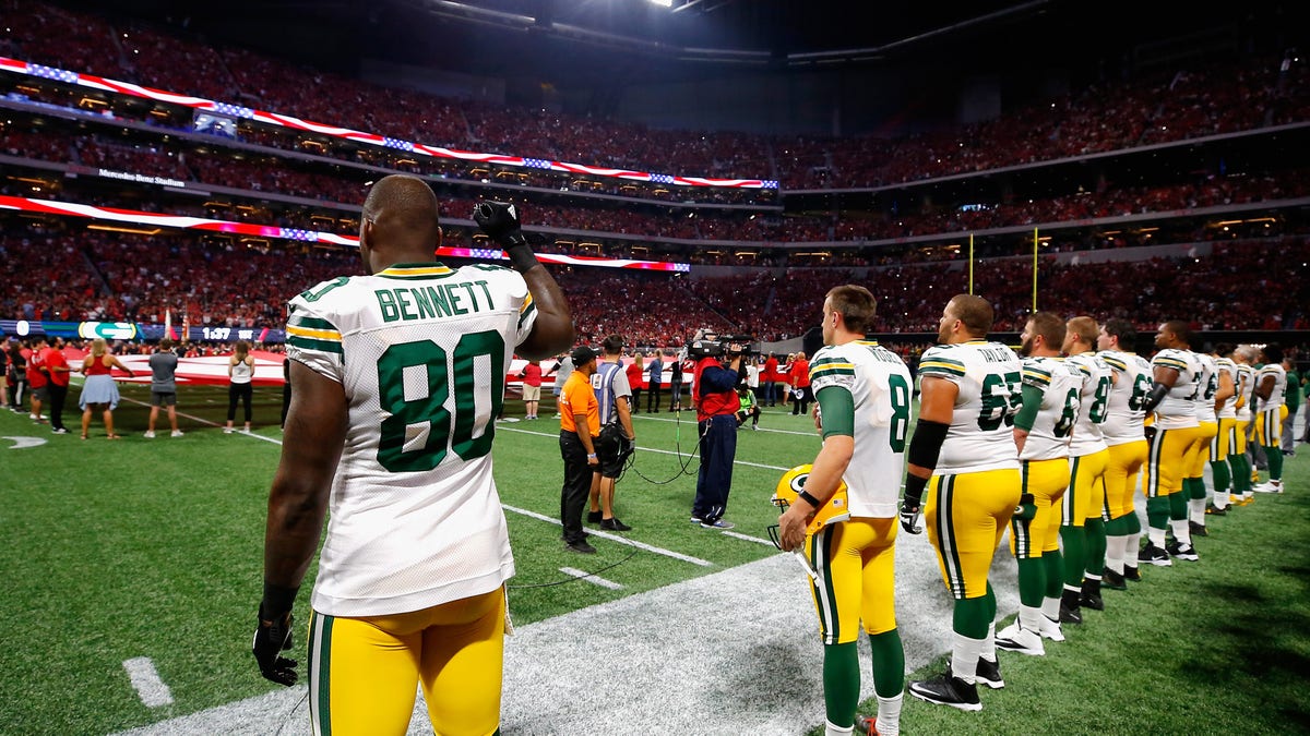 Martellus Bennett #80 of the Green Bay Packers raises his fist during the national anthem prior to the game between the Green Bay Packers and the Atlanta Falcons at Mercedes-Benz Stadium on Sept. 17, 2017 in Atlanta, Georgia.  (Photo by Kevin C. Cox/Getty Images)