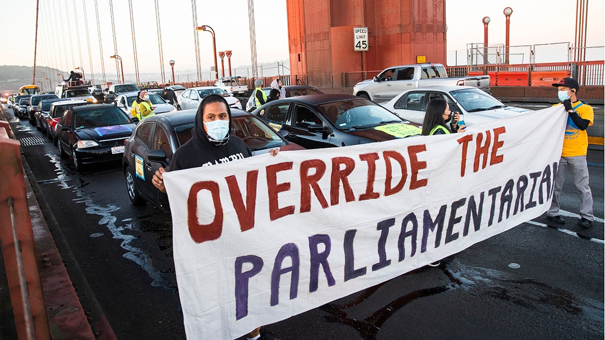 SAN FRANCISCO, CA - SEPTEMBER 30: Protesters block northbound traffic on the Golden Gate Bridge in San Francisco, CA. Thursday, September 30, 2021 during a demonstration demanding Congress grant a pathway to citizenship for the country's 11 million undocumented people. (Jessica Christian/The San Francisco Chronicle via Getty Images)