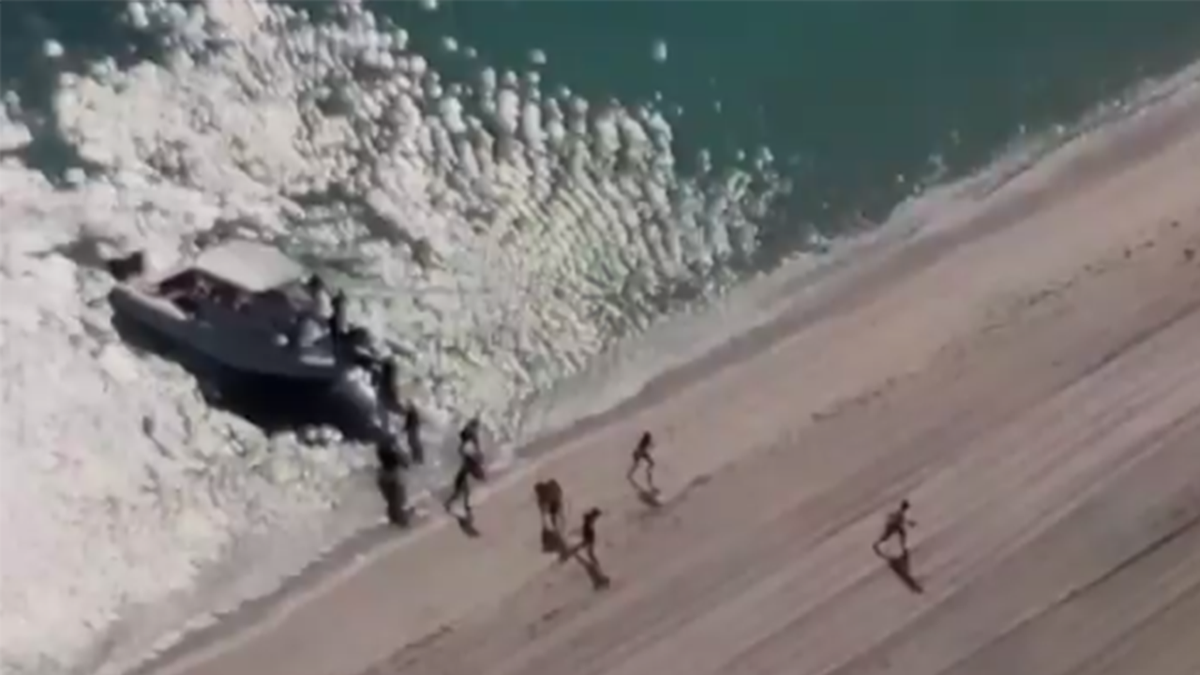 Video showing Haitian migrants jumping off a boat at a South Florida beach.