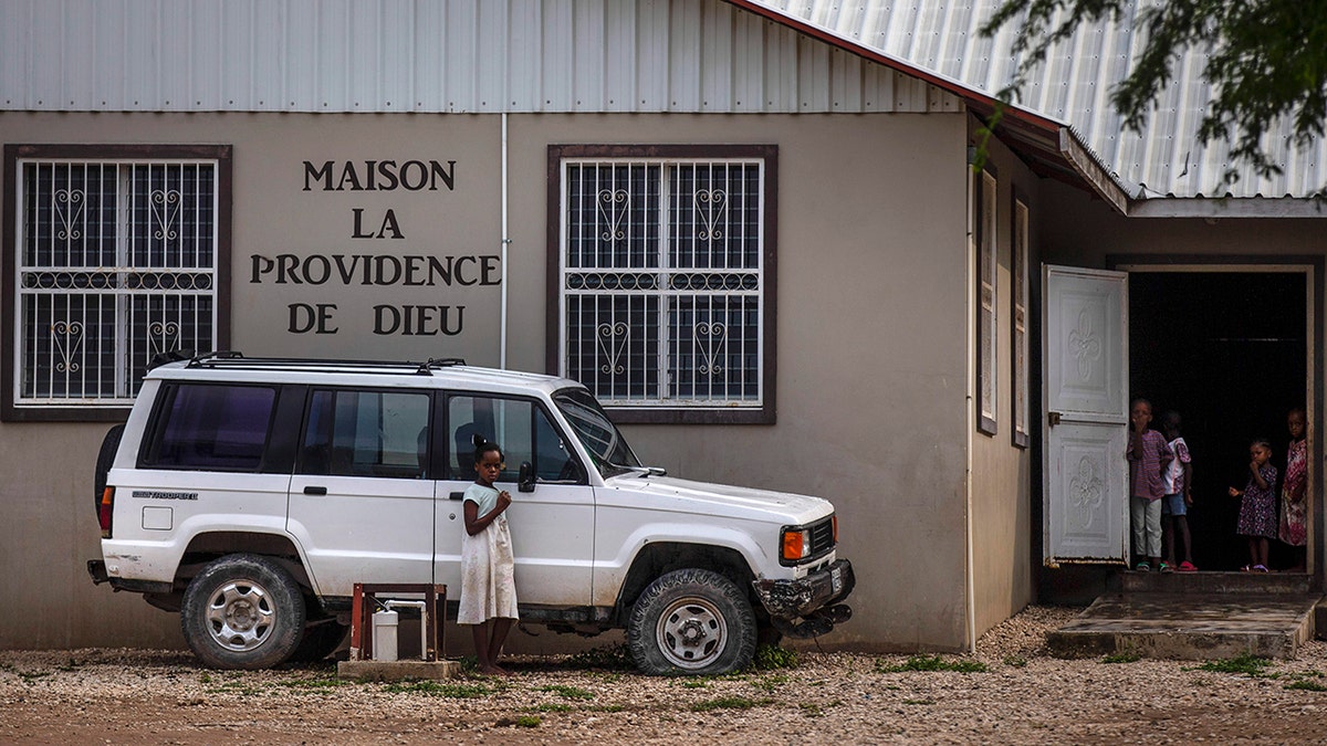 Children stand in the courtyard of the Maison La Providence de Dieu orphanage it Ganthier, Croix-des-Bouquets, Haiti, on Sunday where a gang abducted 17 missionaries from a U.S.-based organization.