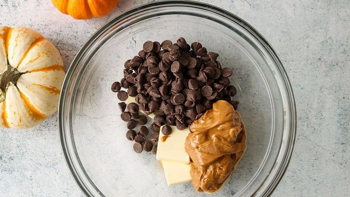 Kate Kasbee and American Licorice Company shared a sour punch Halloween muddy buddies recipe with Fox News. First, you'll need to combine chocolate chips, peanut butter, and butter in a microwave-safe bowl.