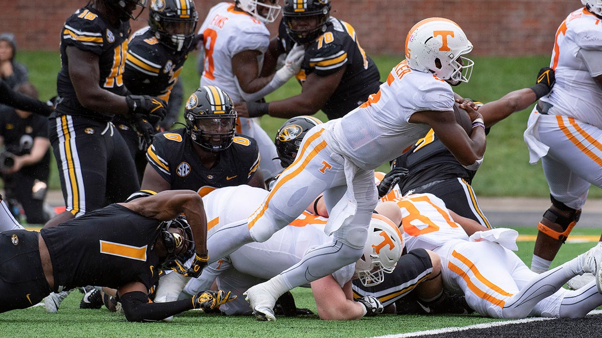 Tennessee quarterback Hendon Hooker, right, scores a touchdown during the second quarter of an NCAA college football game against Missouri Saturday, Oct. 2, 2021, in Columbia, Mo.