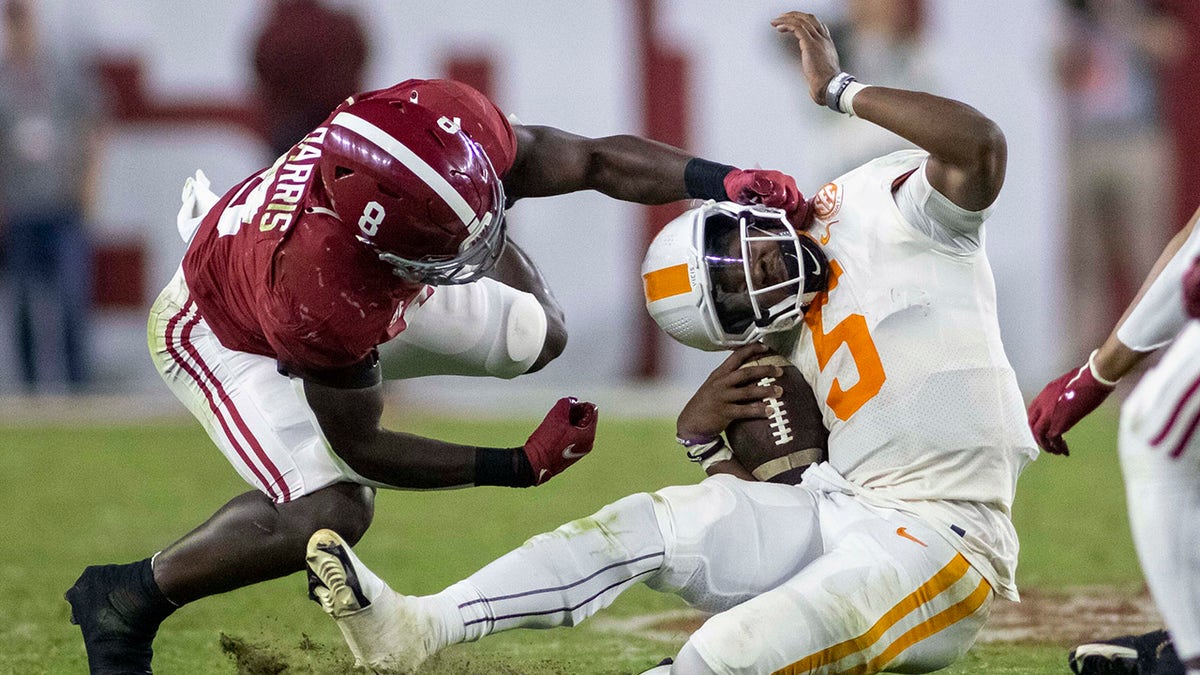 Alabama defensive back Jordan Battle (9) tackles Tennessee quarterback Hendon Hooker (5) during the second half of an NCAA college football game, Saturday, Oct. 23, 2021, in Tuscaloosa, Ala.