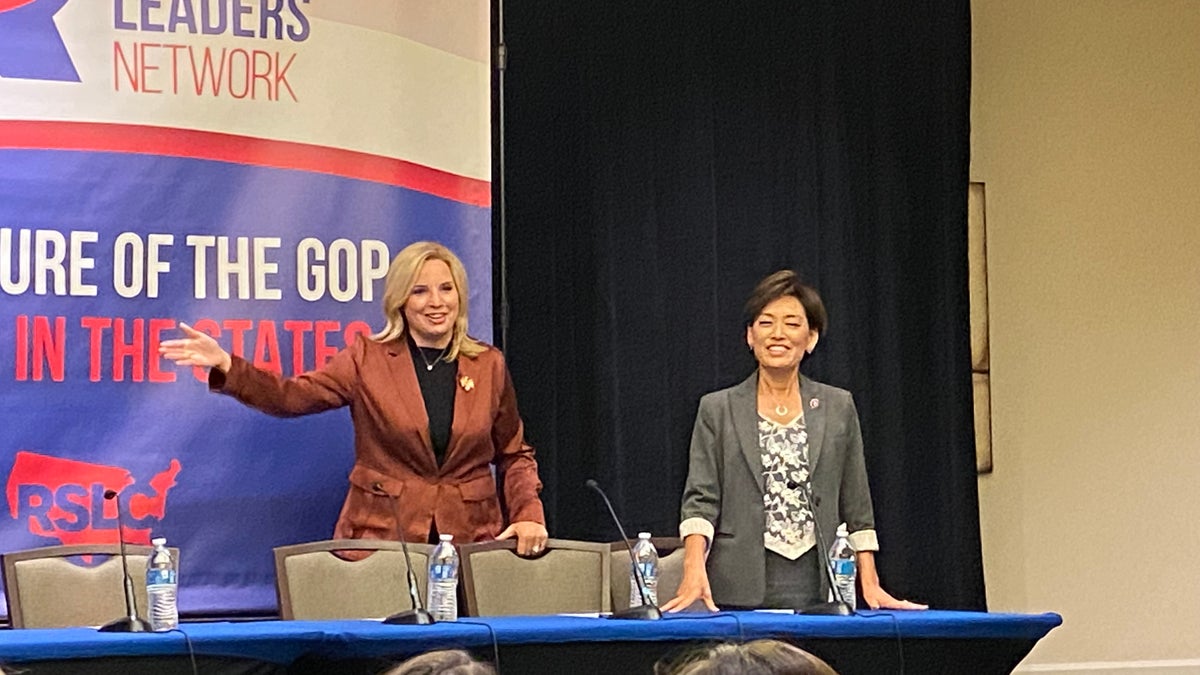 Reps. Ashley Hinson, R-Iowa, and Young Kim, R-Calif., gesture as they take the stage at a Republican State Leadership Committee (RSLC) event on Wednesday, Oct. 20, 2021. (Tyler Olson/Fox News)