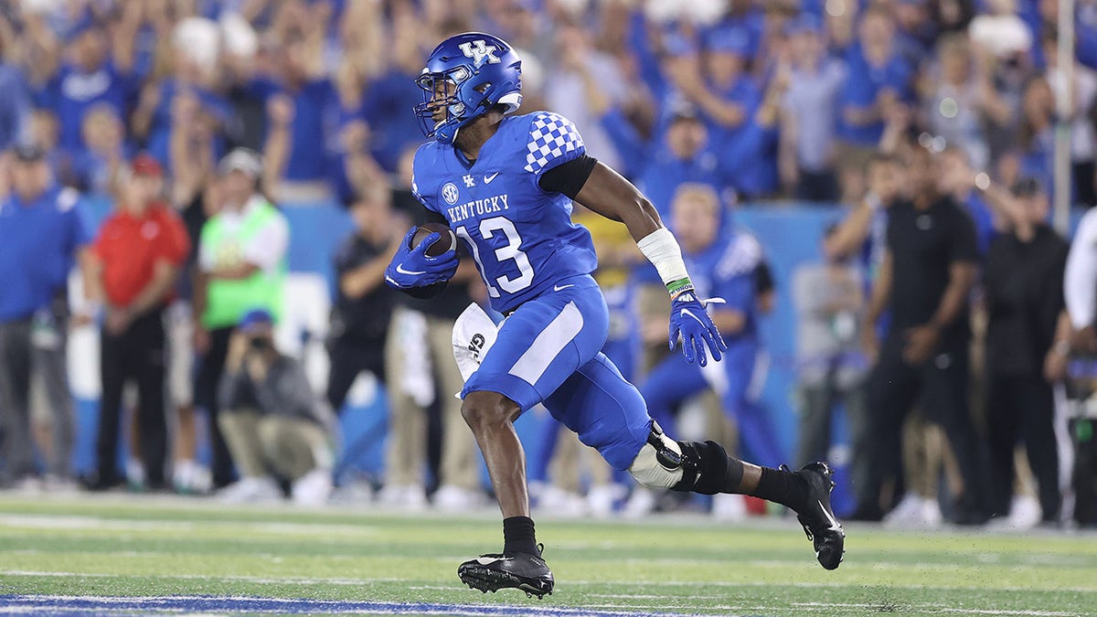 J.J. Weaver #13 of the Kentucky Wildcats runs with the ball after intercepting a pass against the Florida Gators at Kroger Field on October 02, 2021 in Lexington, Kentucky.