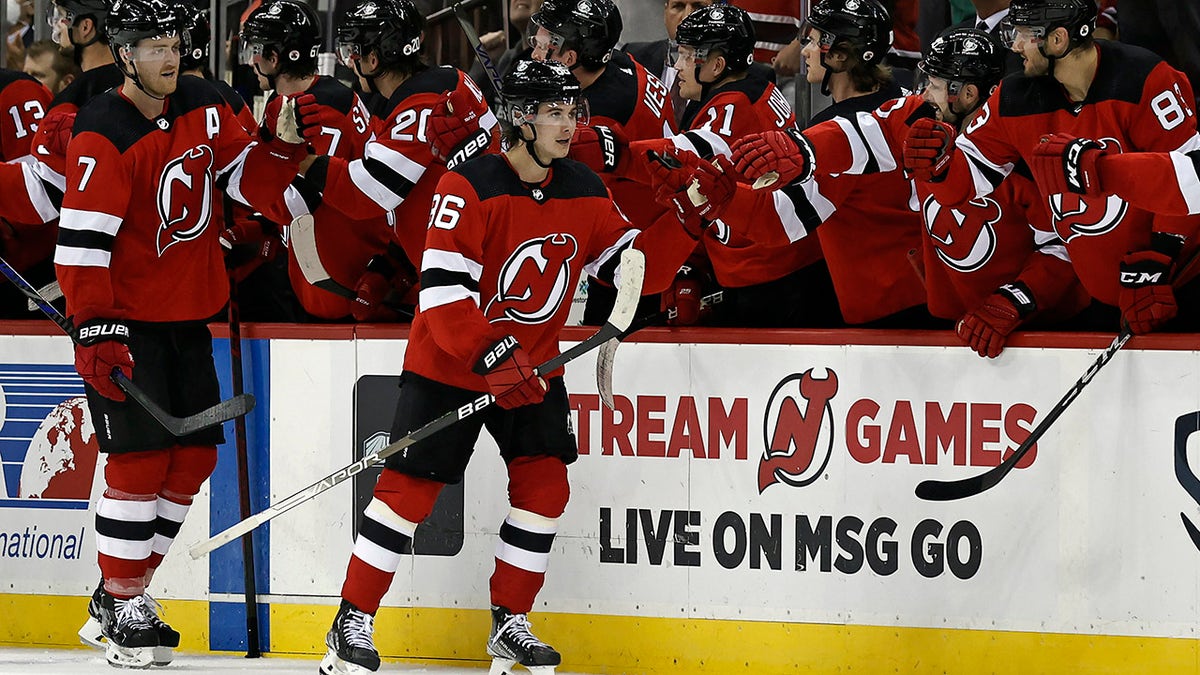 New Jersey Devils center Jack Hughes (86) celebrates with teammates after scoring a goal against the Chicago Blackhawks during the second period of an NHL hockey game Friday, Oct. 15, 2021, in Newark, N.J.