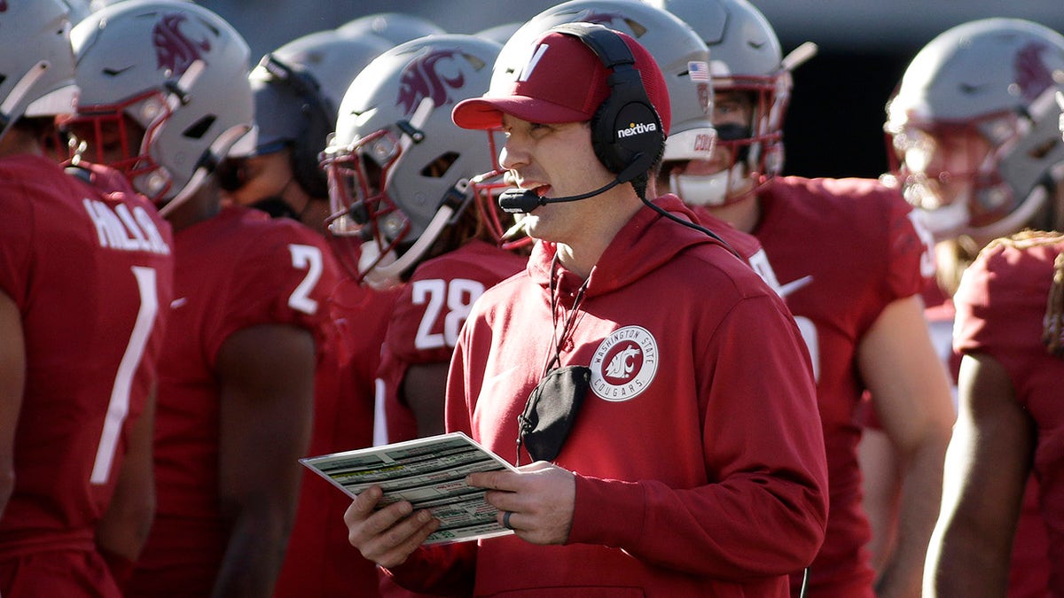 Washington State defensive coordinator and linebackers coach Jake Dickert, center, stands on the field during a break in play in the second half of an NCAA college football game, Saturday, Oct. 9, 2021, in Pullman, Wash. Dickert was named Washington State interim head coach, Monday, Oct. 18 after head coach Nick Rolovich was fired for refusing a state mandate that all employees get vaccinated against COVID-19.
