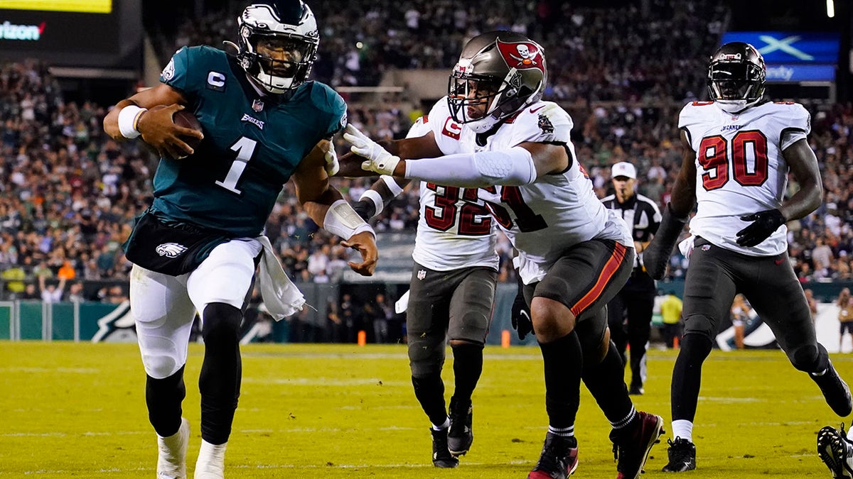 Philadelphia Eagles quarterback Jalen Hurts (1) runs with the ball under pressure during the second half of an NFL football game against the Tampa Bay Buccaneers on Thursday, Oct. 14, 2021, in Philadelphia.