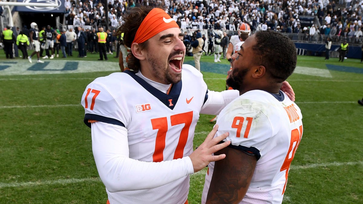 llinois players James McCourt (17) and Jamal Woods (91) celebrate their 20-18 victory over Penn State after the ninth overtime of an NCAA college football game in State College, Pa.on Saturday, Oct. 23, 2021.