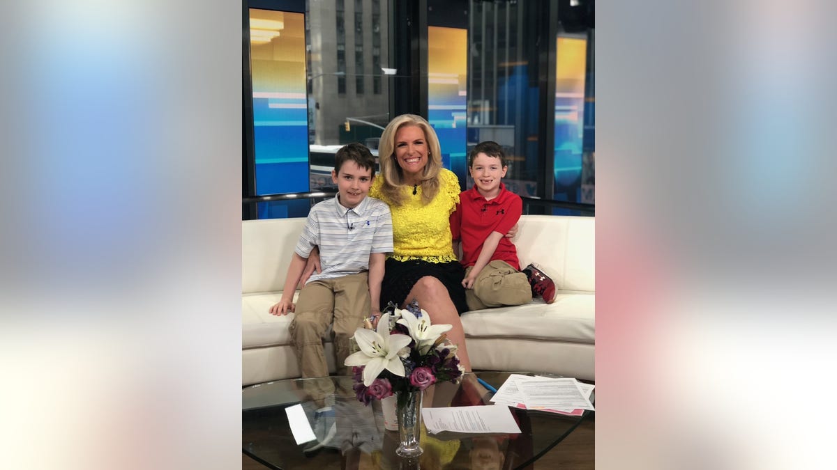 Janice Dean with her two sons on the "Fox and Friends" curvy couch.