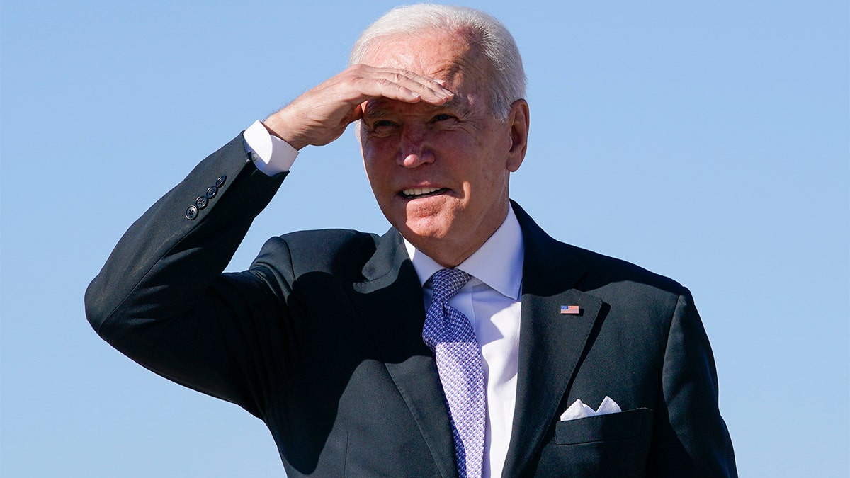 President Joe Biden shields his eyes from the sun as he walks toward Air Force One at Andrews Air Force Base, Md., Wednesday, Oct. 20, 2021. (AP Photo/Susan Walsh)