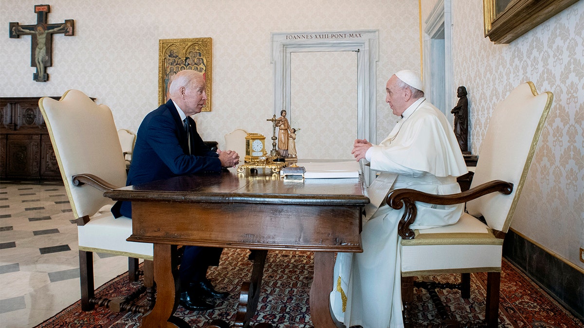US President Joe Biden, left, talks with Pope Francis as they meet at the Vatican, Friday, Oct. 29, 2021.  (Vatican Media via AP)