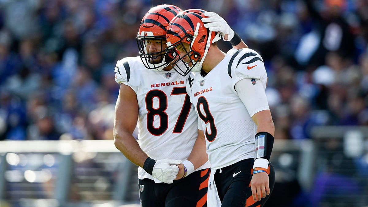 Cincinnati Bengals tight end C.J. Uzomah (87) and quarterback Joe Burrow (9) react after they connected for a touchdown pass during the second half of an NFL football game, Sunday, Oct. 24, 2021, in Baltimore.