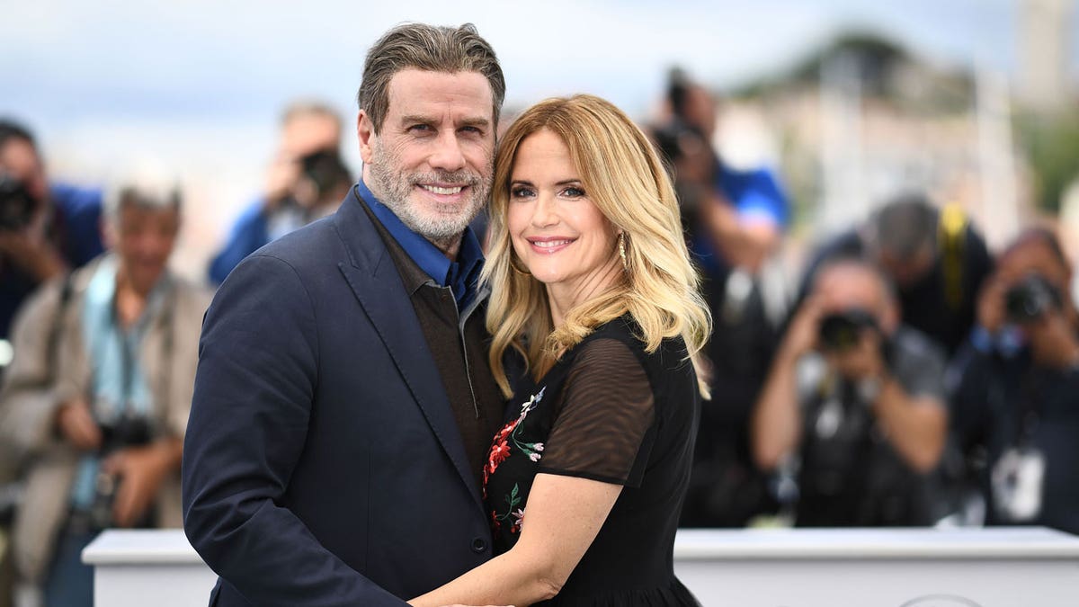 John Travolta and his wife Kelly Preston pose on May 15, 2018 during a photocall for the film 'Gotti' at the 71st edition of the Cannes Film Festival in Cannes, southern France.