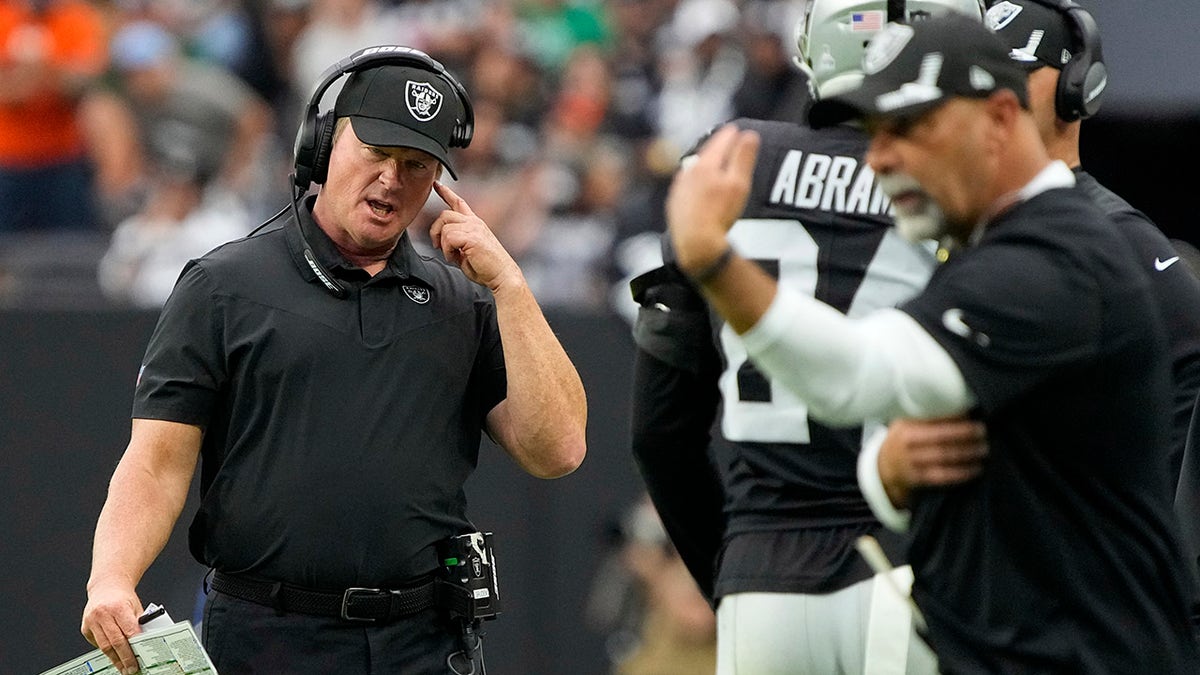 Las Vegas Raiders head coach Jon Gruden speaks on his headset during the first half of an NFL football game against the Chicago Bears, Sunday, Oct. 10, 2021, in Las Vegas.