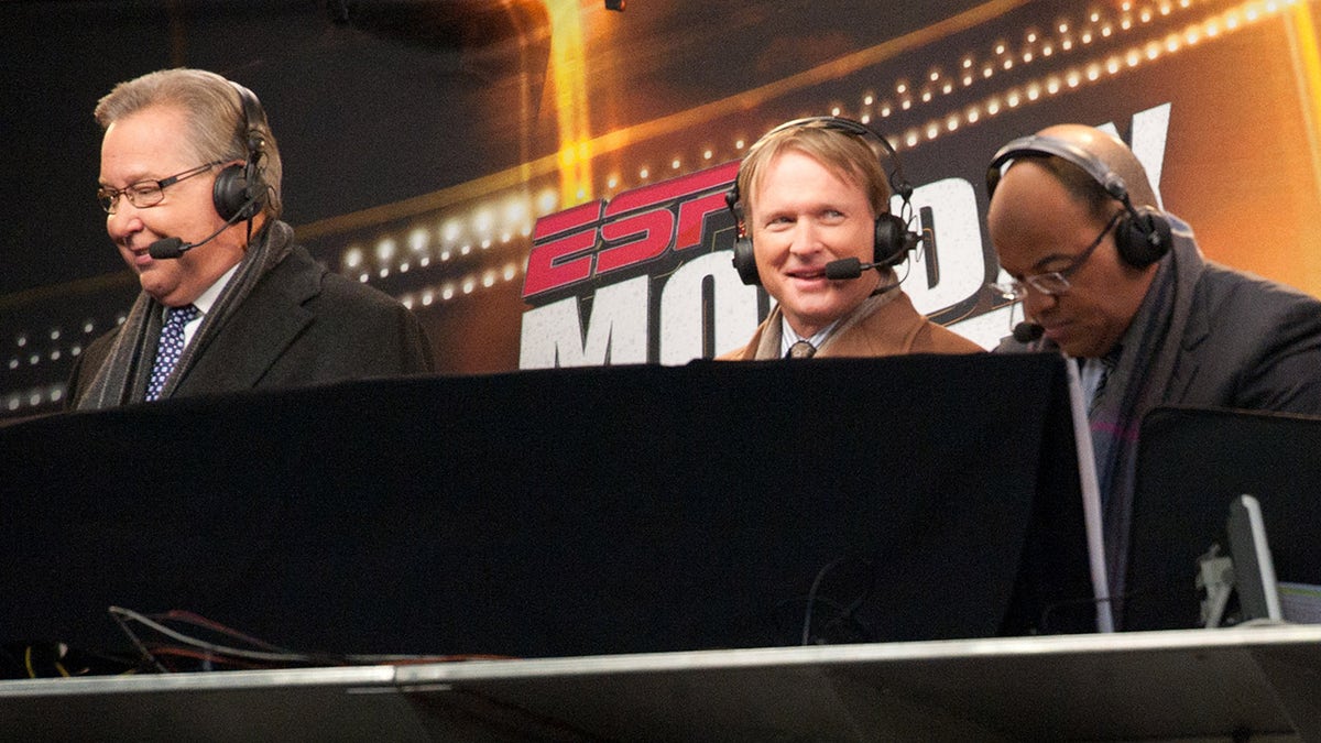 Members of the Monday Night announcing crew Ron Jaworski, John Gruden and Mike Tirico of ESPN look on during the game between the New England Patriots and the New York Jets at Gillette Stadium on December 06, 2010 in Foxboro, Massachusetts.