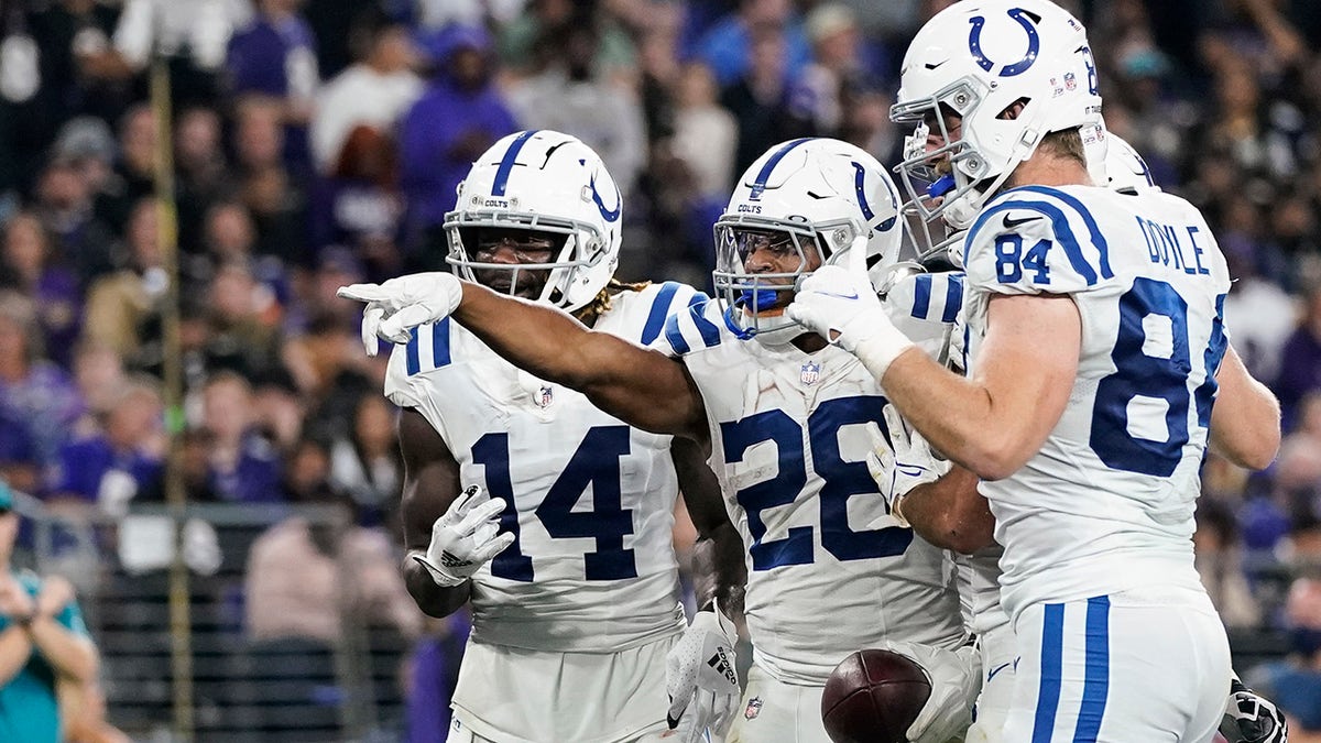 Indianapolis Colts running back Jonathan Taylor (28) celebrates his touchdown with his teammates during the second half of an NFL football game against the Baltimore Ravens, Monday, Oct. 11, 2021, in Baltimore.