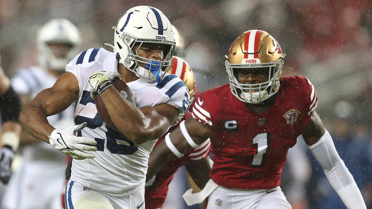 Indianapolis Colts running back Jonathan Taylor, left, runs in front of San Francisco 49ers free safety Jimmie Ward (1) during the first half of an NFL football game in Santa Clara, Calif., Sunday, Oct. 24, 2021.