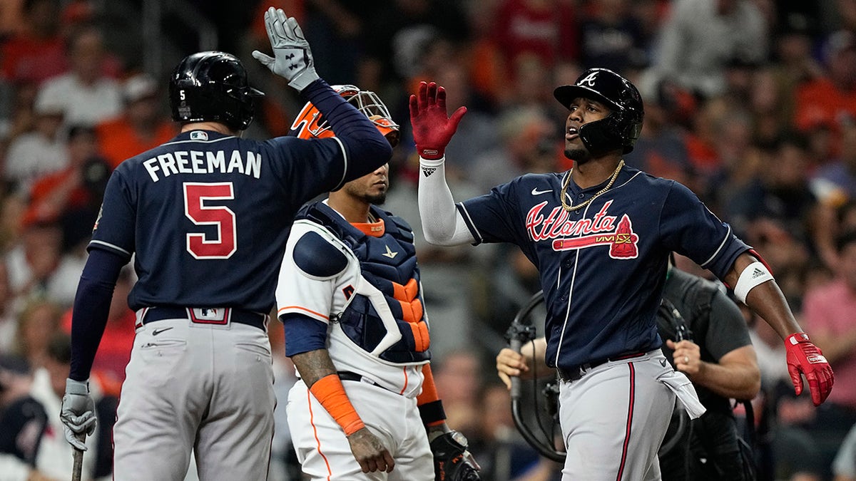 Atlanta Braves' Jorge Soler celebrates his home run with Freddie Freeman during the first inning of Game 1 in baseball's World Series between the Houston Astros and the Atlanta Braves Tuesday, Oct. 26, 2021, in Houston.