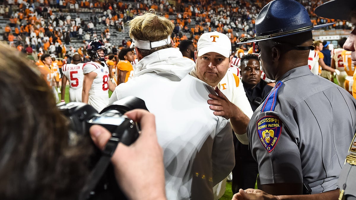 Oct 16, 2021; Knoxville, Tennessee, USA; Tennessee Volunteers head coach Josh Heupel (facing camera) and Mississippi Rebels head coach Lane Kiffin meet at mid field after a game at Neyland Stadium.