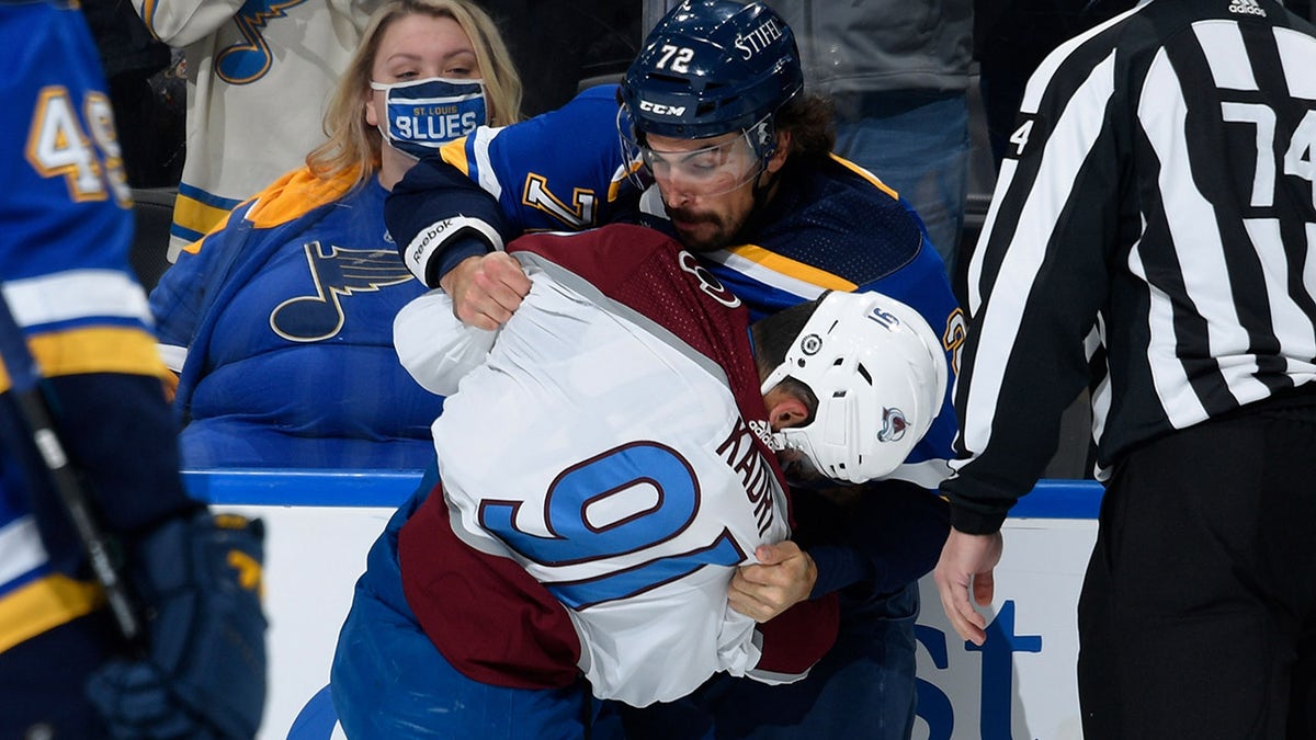 Justin Faulk of the St. Louis Blues and Nazem Kadri (91) of the Colorado Avalanche fight during the game at the Enterprise Center on Oct. 28, 2021, in St. Louis, Missouri.