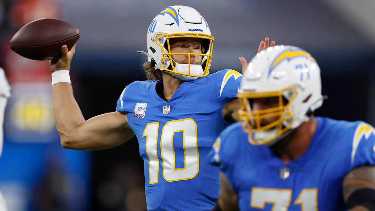 Quarterback Justin Herbert #10 of the Los Angeles Chargers passes against the Las Vegas Raiders during the first half at SoFi Stadium on October 4, 2021 in Inglewood, California.