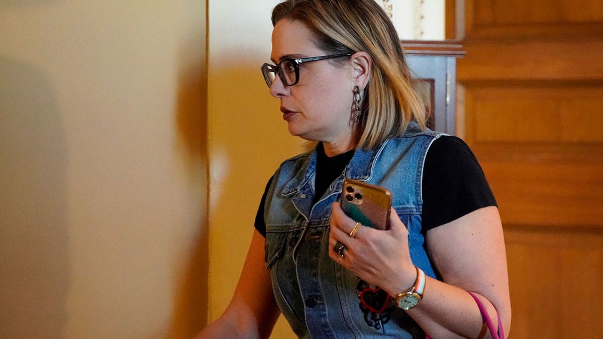 U.S. Senator Kyrsten Sinema (D-AZ) leaves the Senate Democrats weekly policy lunch at the U.S. Capitol in Washington, U.S., October 26, 2021. REUTERS/Elizabeth Frantz