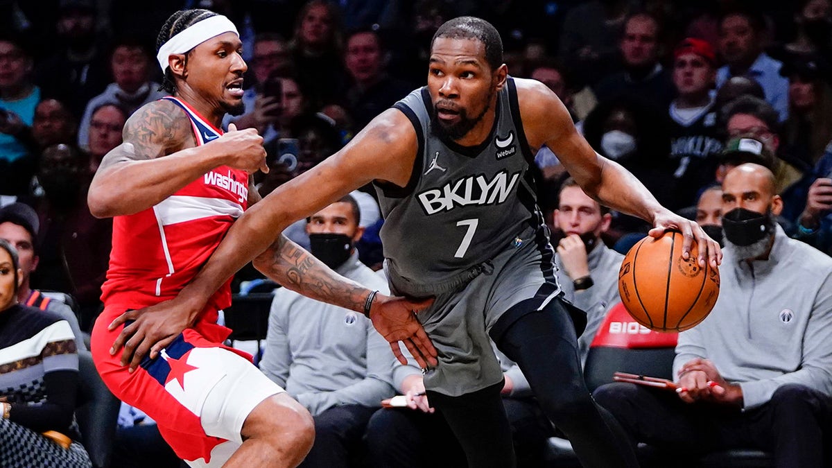 Brooklyn Nets' Kevin Durant (7) drives past Washington Wizards' Bradley Beal (3) during the second half of an NBA basketball game Monday, Oct. 25, 2021, in New York. The Nets won 104-90.