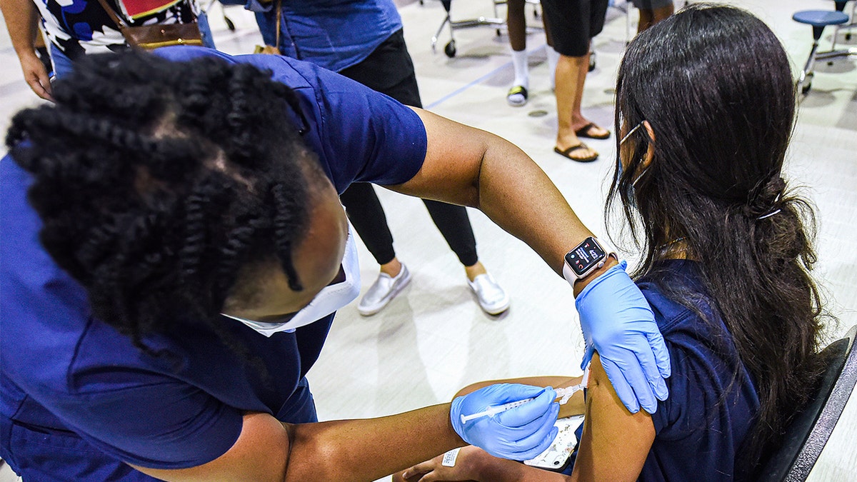 girl gets vaccine