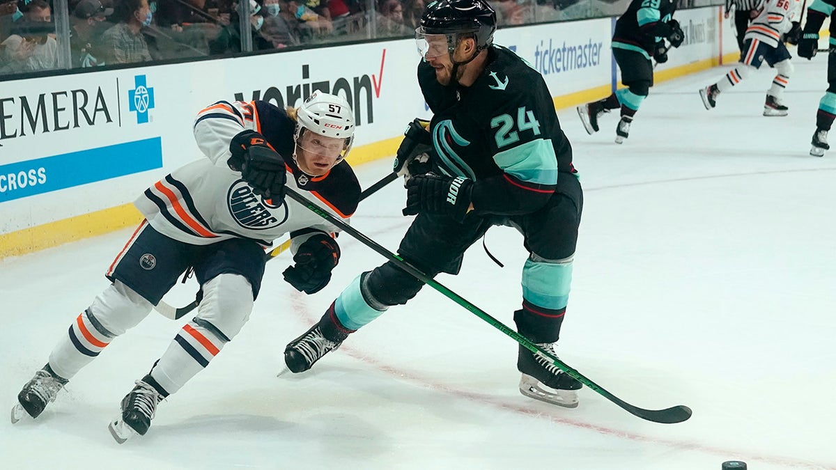 Edmonton Oilers' James Hamblin (57) skates past Seattle Kraken's Jamie Oleksiak (2) in the first period of a preseason NHL hockey game Friday, Oct. 1, 2021, in Everett, Wash.