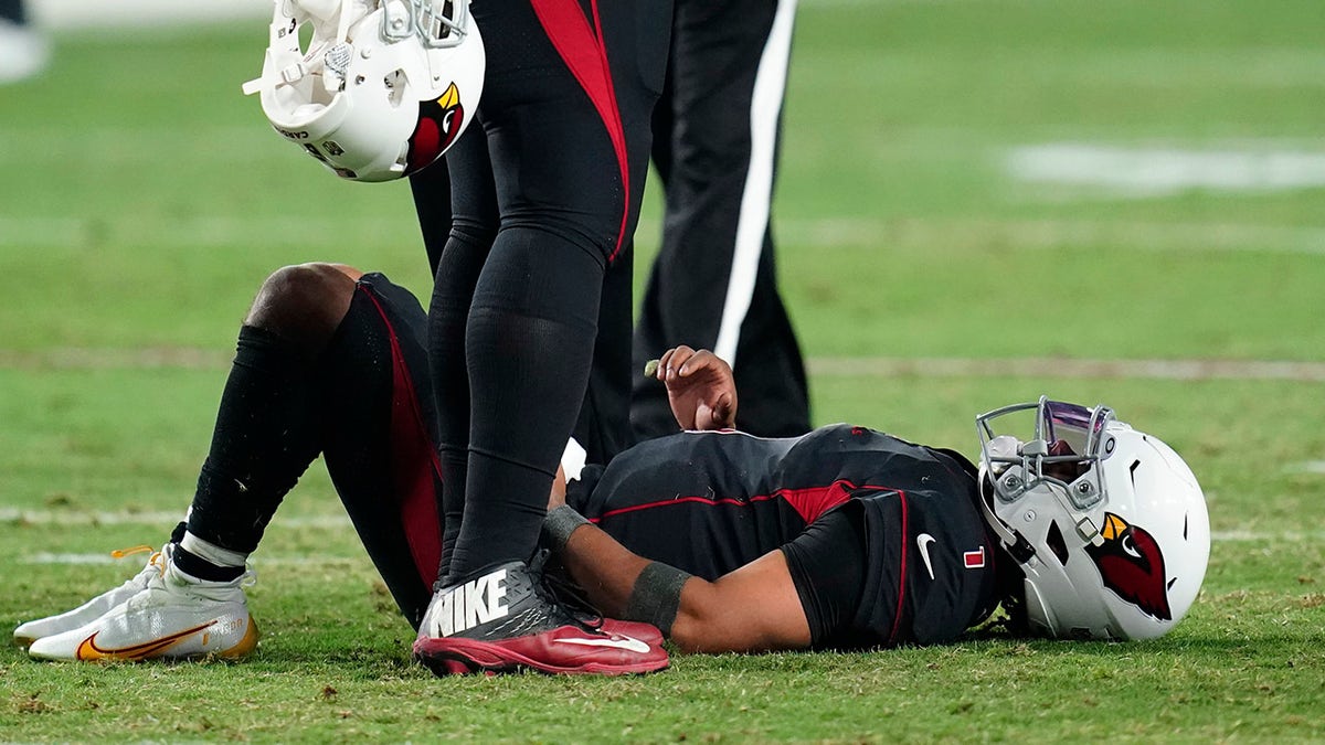 Arizona Cardinals quarterback Kyler Murray lies on the field after being hit during the second half of an NFL football game against the Green Bay Packers, Thursday, Oct. 28, 2021, in Glendale, Ariz. The Packers won 24-21.