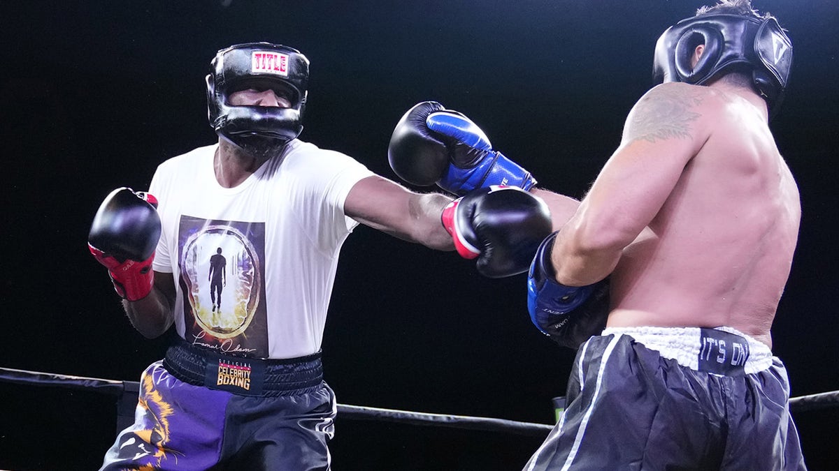 Lamar Odom punches Ojani Noa during the second round of the Celebrity Boxing Miami 2021 Lamar Odom vs Ojani Noa at the James L. Knight Center on October 02, 2021 in Miami, Florida.