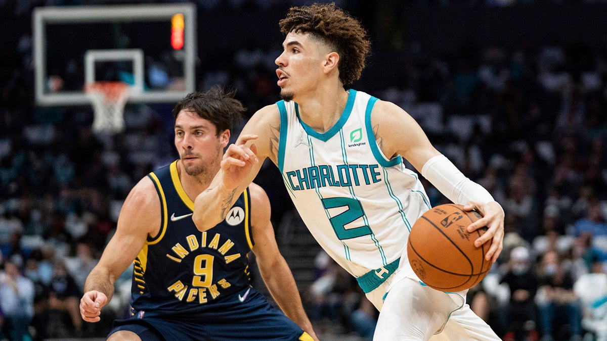 Charlotte Hornets guard LaMelo Ball (2) drives to the basket while guarded by Indiana Pacers guard T.J. McConnell (9) in Charlotte, N.C., Oct. 20, 2021.