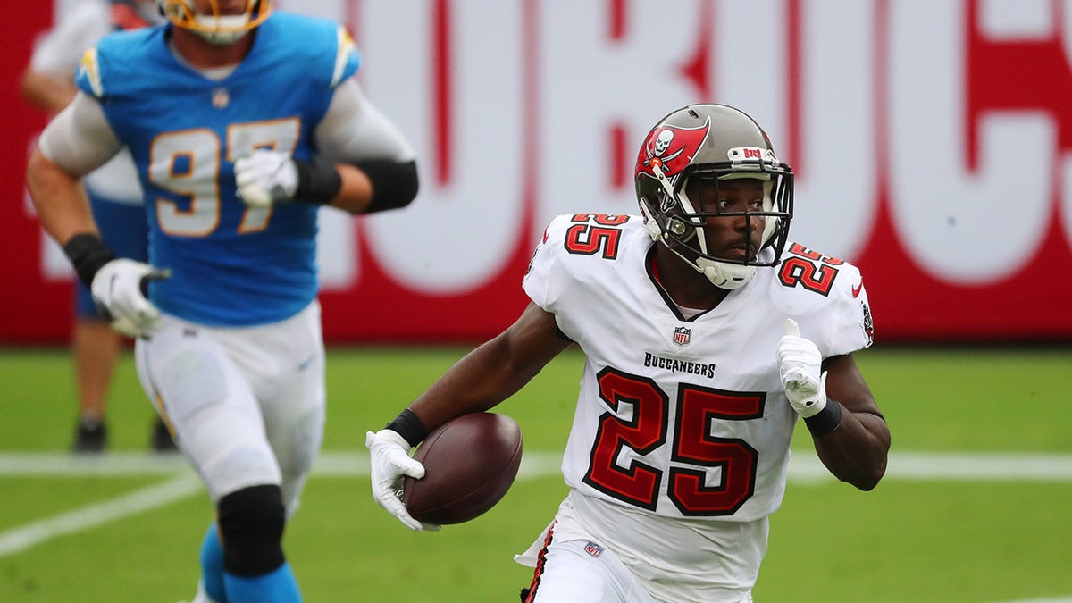Oct 4, 2020; Tampa, Florida, USA;  Tampa Bay Buccaneers running back LeSean McCoy (25) runs the ball against the Los Angeles Chargers in the first quarter of a NFL game at Raymond James Stadium.