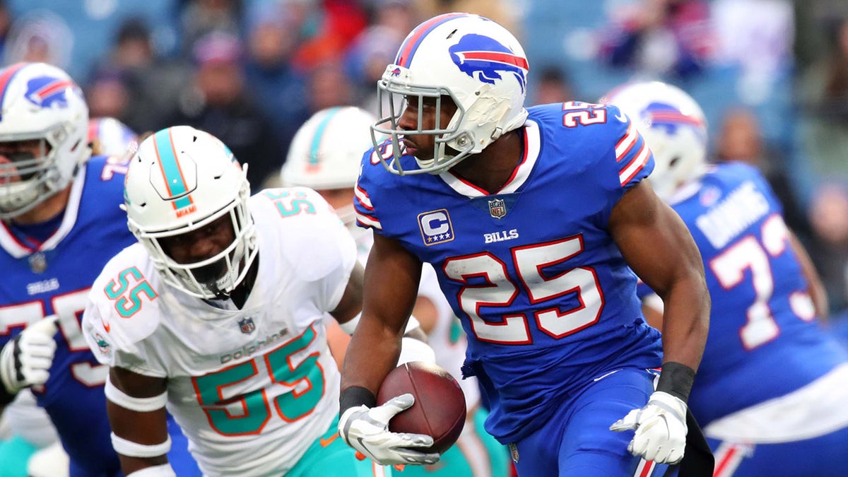 Dec 30, 2018; Orchard Park, NY, USA; Buffalo Bills running back LeSean McCoy (25) runs with the ball past Miami Dolphins outside linebacker Jerome Baker (55) during the first quarter at New Era Field.